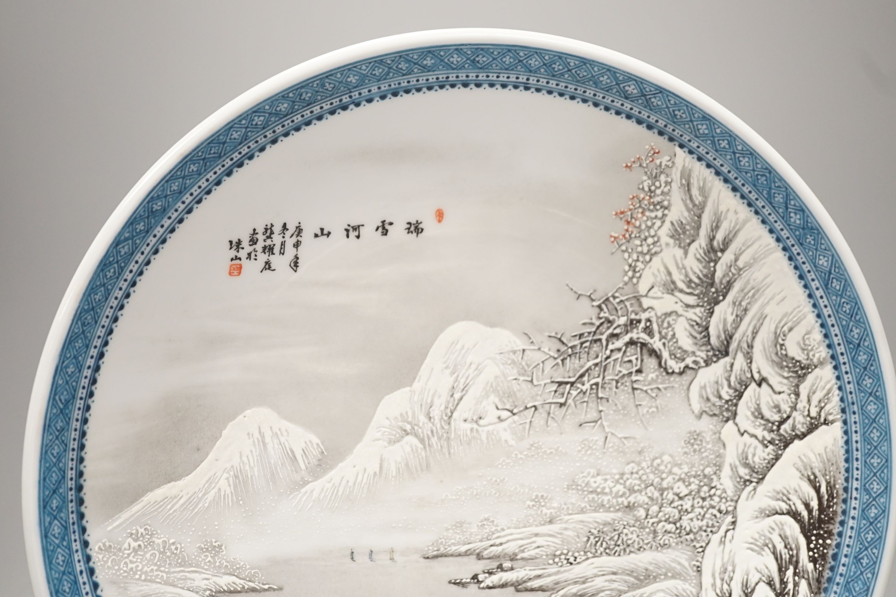 A Chinese enamelled porcelain snow scene dish, diameter 31cm, and a similar smaller eggshell bowl